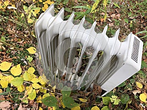 Closeup on White Radiator Heater Outdoors in Grass
