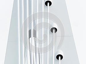 Closeup of white suspension cables on a metal structure on white background