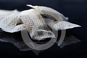 Closeup of a white swedish snus can and portion snuff pouches