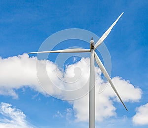 Closeup of wind turbine producing alternative energy in wind far