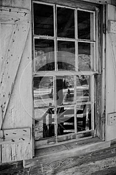 Closeup of windowpanes and shutters from civil war era 1800slog cabin in Callaway gardens in Georgia