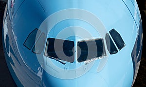 Closeup of the windows of a blue  airplane cockpit