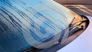 Closeup of windshield wiper covered rain drop in the morning