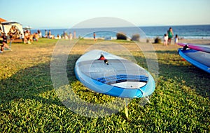 Windsurfing boards on the beach of Bolonia at sunset, Coast of Cadiz, southern Spain photo