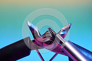 Closeup of wirecutter pliers and screwdriver bit on light blue background photo