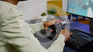 Closeup of wireless joystick and RGB keyboard, pro video gamer playing