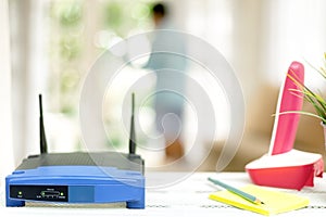 closeup of a wireless router on living room at home with a window in the background