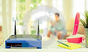 closeup of a wireless router on living room at home with a window in the background
