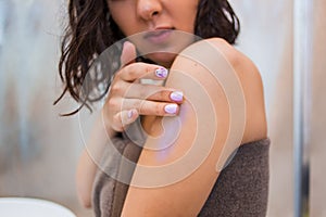 Closeup of woman applies on the body, hands scrub, mask, lotion. Spa, care