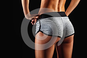 Closeup woman buttocks over dark