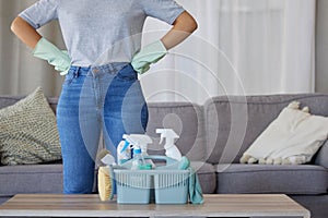 Closeup of woman, cleaning and basket with product in living room, lounge and home of housekeeping, maintenance or