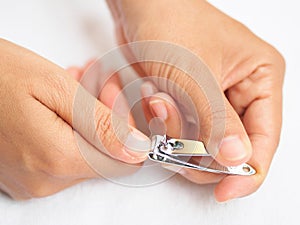 Closeup of a woman cutting nails