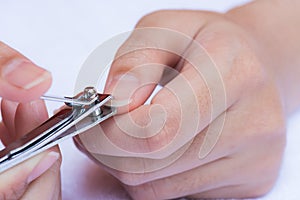 Closeup of a woman cutting nails