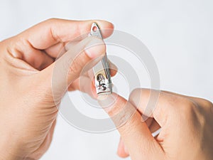 Closeup of a woman cutting nails