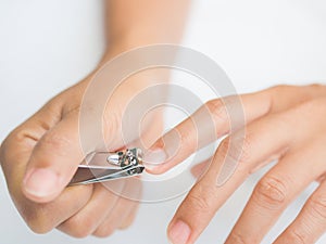 Closeup of a woman cutting nails, health care concept.