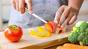 Closeup on woman cutting vegetables in the kitchen. Healthy eating concept