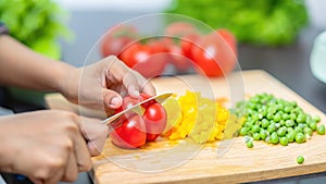 Closeup on woman cutting vegetables in the kitchen. Healthy eating concept