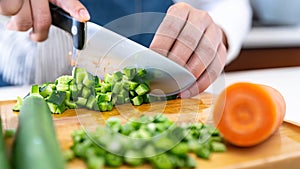 Closeup on woman cutting vegetables in the kitchen. Healthy eating concept