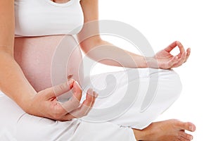 Closeup of woman doing meditative pregnancy yoga