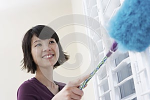 Closeup Of Woman Dusting