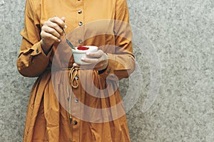 Closeup woman eating algerian homemade vanilla caramel custard desert, flan
