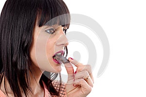 Closeup of woman eating chocolate