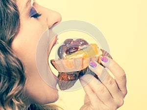 Closeup woman eating fruit cake sweet food