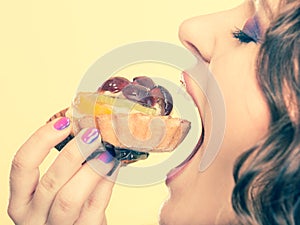 Closeup woman eating fruit cake sweet food