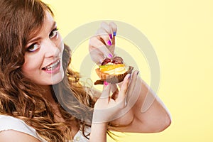 Closeup woman eating fruit cake sweet food