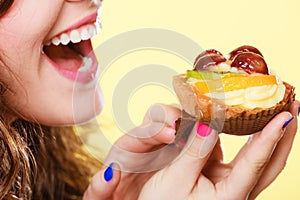 Closeup woman eating fruit cake sweet food