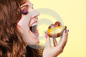 Closeup woman eating fruit cake sweet food