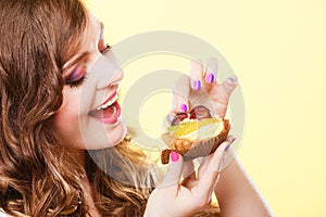 Closeup woman eating fruit cake sweet food