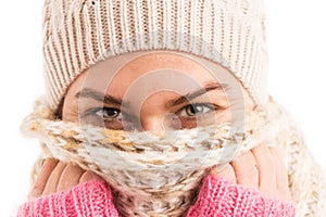 Closeup of woman eyes wearing knitted scarf and hat