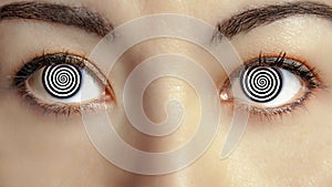 Closeup woman face with hypnotized eyes photo