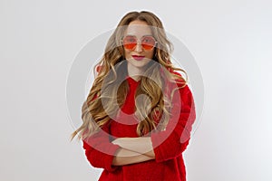 Closeup woman face in red sunglasses isolated on white background. Girl in red hoodie sweatshirt and red lips makeup. Fashion