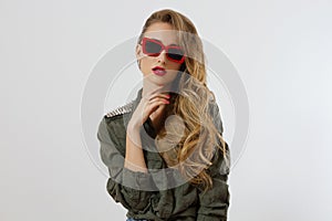 Closeup woman face in red sunglasses isolated on white background. Girl in shirt, red lips makeup. Fashion Beauty concept.