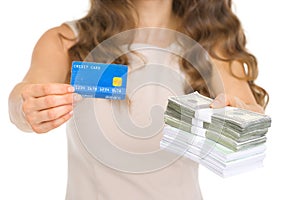 Closeup on woman giving credit card and money