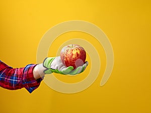 Closeup on woman grower showing an apple
