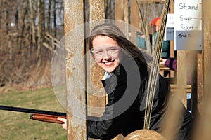 Closeup woman with gun at trap shooting range