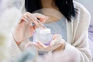 Closeup woman hand applying cream ,taking moisturizer for skin hand ,face