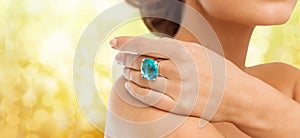 Closeup of woman hand with big blue cocktail ring