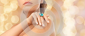 Closeup of woman hand with big blue cocktail ring