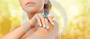 Closeup of woman hand with big blue cocktail ring