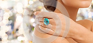 Closeup of woman hand with big blue cocktail ring