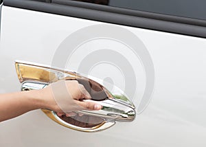 Closeup woman hand on car door handle, selective focus