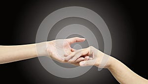 Closeup woman hand hold another woman hand for console and encourage in tender emotion isolated on black background