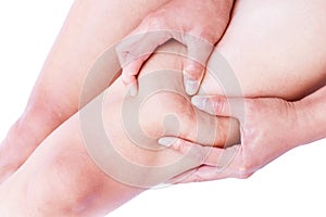 Closeup woman hand holding the skin of legs cellulite for beaut
