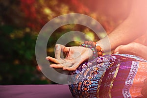 Closeup of woman hand in mudra gesture practice yoga meditation photo