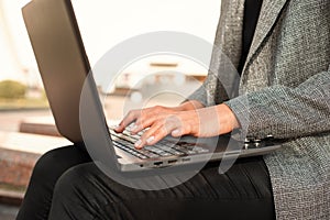 Closeup of woman hand typing on laptop keyboard