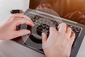 Closeup woman hand using laptop with modern office